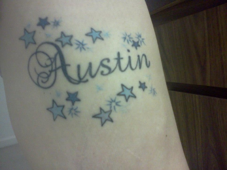 a tattoo with the word austin written in blue and silver stars on it's side