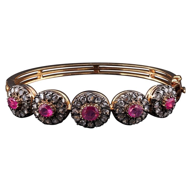 A gorgeous Diamond and Ruby rare bangle that is in the Victorian tradition, 1890 ca Hand crafted of solid 18 Kt gold with portions of silver for the Diamond housing Stunning riviere design of multiple Diamond and Ruby clusters composing an array of oval sections of great impact and pleasing effect Each cluster is composed by a centre natural Ruby set in a frame of Rose Cut Diamonds for a lovely twinkling vision, Ruby measures range between 5.25 x 7.94 mm. to 5.19 x 4.78 mm. average sizes, approx Ruby Set, Ruby Rose, Natural Ruby, Rose Cut Diamond, Rose Cut, Cuff Bracelet, Bangle Bracelets, Diamond Cuts, Ruby