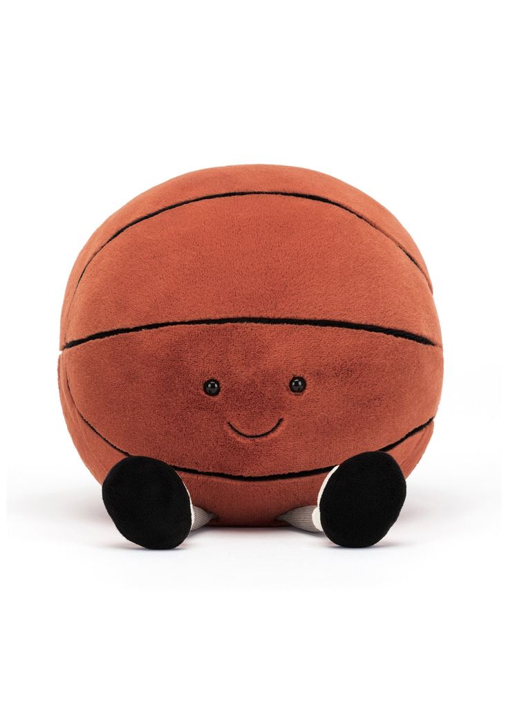 a basketball stuffed animal sitting on top of a white floor next to a black ball