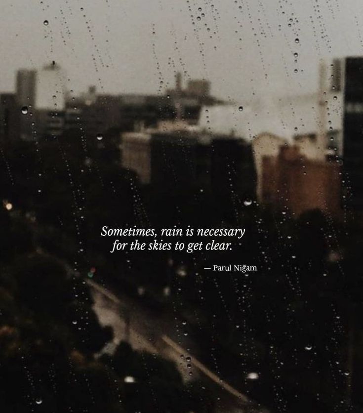 rain drops on the window and cityscape in the background with an inspirational quote