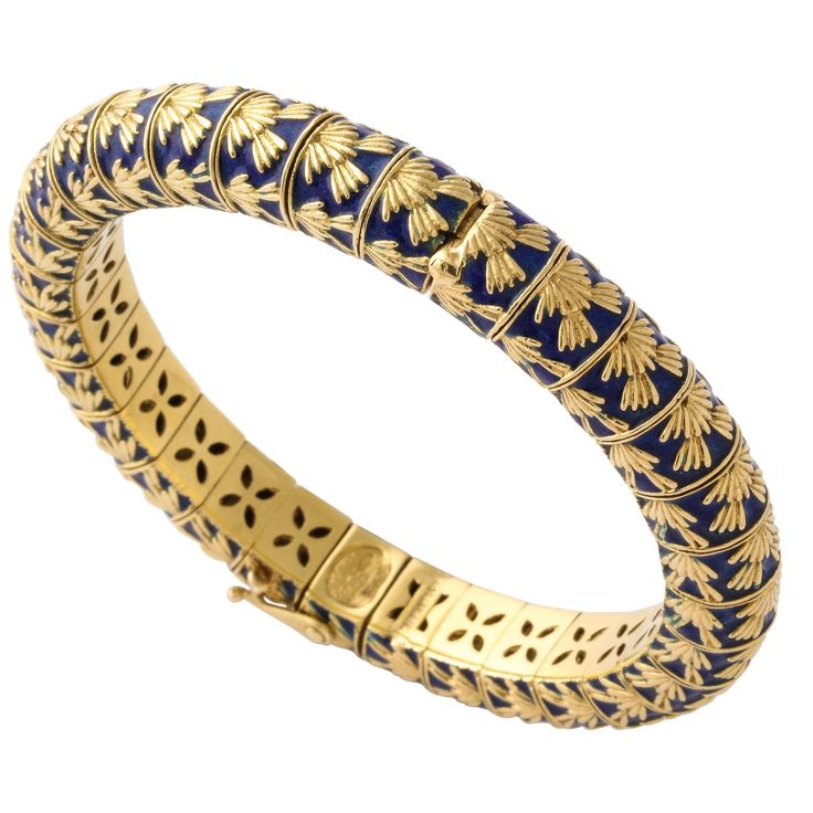 We offer a perfectly elegant 1960s Tiffany & Co. - Paris bangle bracelet of 18K gold segments with rich blue enameled details with a slight flexibility and hinged for easy on and off with a safety latch and safety chain. Wear it stacked or fashionably on its own. It fits a 6 1/2 inch wrist. Weighs 91.8 grams. Marked Tiffany & Co. and Modell FC Depose. 750 French gold mark. Tiffany Bracelet, Gold Tiffany, Gold Vans, Haute Jewelry, Ruby Bangles, Sabyasachi Jewellery, Tiffany Bracelets, Gold Rings Fashion, Authentic Jewelry