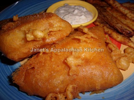 fried fish and fries on a blue plate with ranch dip in the middle next to them