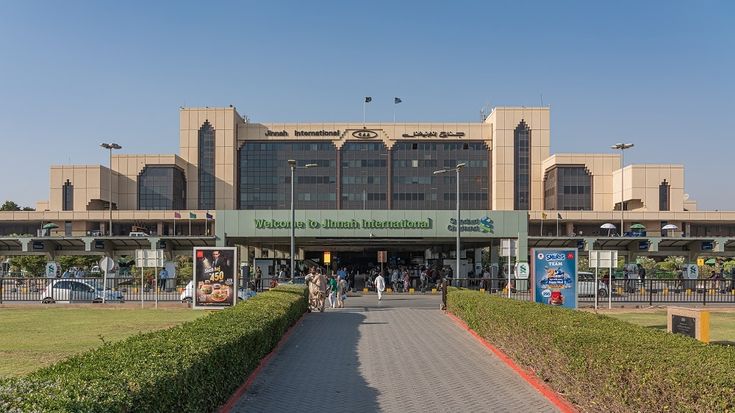 people are walking in front of a large building