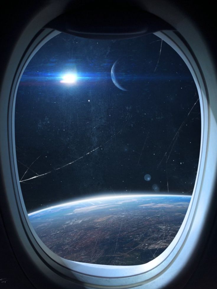 an airplane window looking out at the earth and moon in the sky, as seen from space