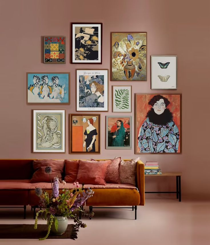 a living room filled with lots of art on the wall above a couch and coffee table