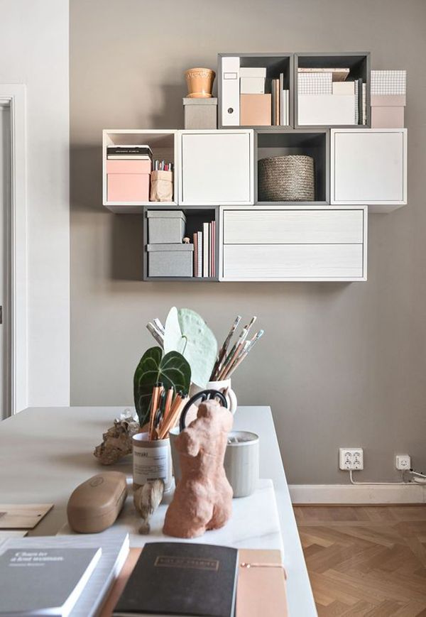 a white table topped with lots of books and vases filled with different types of items