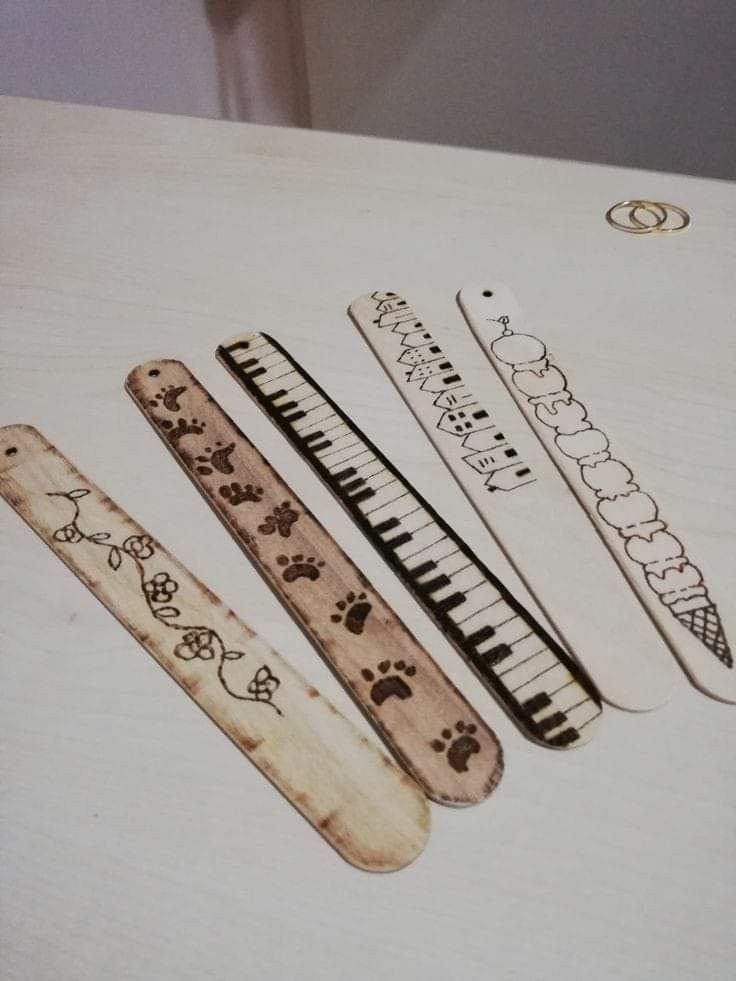 four wooden combs sitting on top of a white table next to an animal print