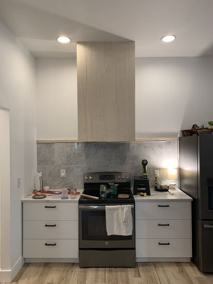 a kitchen with an oven, stove and microwave in it's center island area