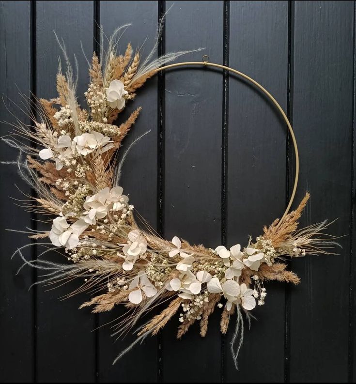 a wreath made out of dried grass and flowers