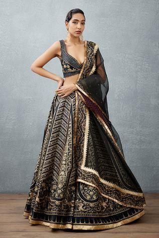 Jet black lehenga in heavy raw silk base with floral bhagalpuri prints. Comes with printed slub silk deep sweetheart neck blouse and polka dotted silk organza dupatta.
Components:3
Pattern:Digital Print
Type of Work:Bhagalpuri Floral, Polka Dots, Leheriya
Neckline:Plunged Sweetheart
Sleeve Type:Sleeveless
Fabric:Pure Bhagalpuri  Silk, Slub Silk, Silk Organza
Color:Black
Other Details:
Leheriya print and gold fringed hem dupatta
Hand adda work with gota highlights
Occasion:Destination Wedding - A Fringe Dupatta, Silk Bralette, Placement Embroidery, Dupatta Style, Printed Lehenga, Black Lehenga, Raw Silk Fabric, Black Pure, Lehenga Collection