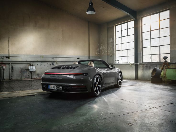 a grey sports car parked in an empty garage