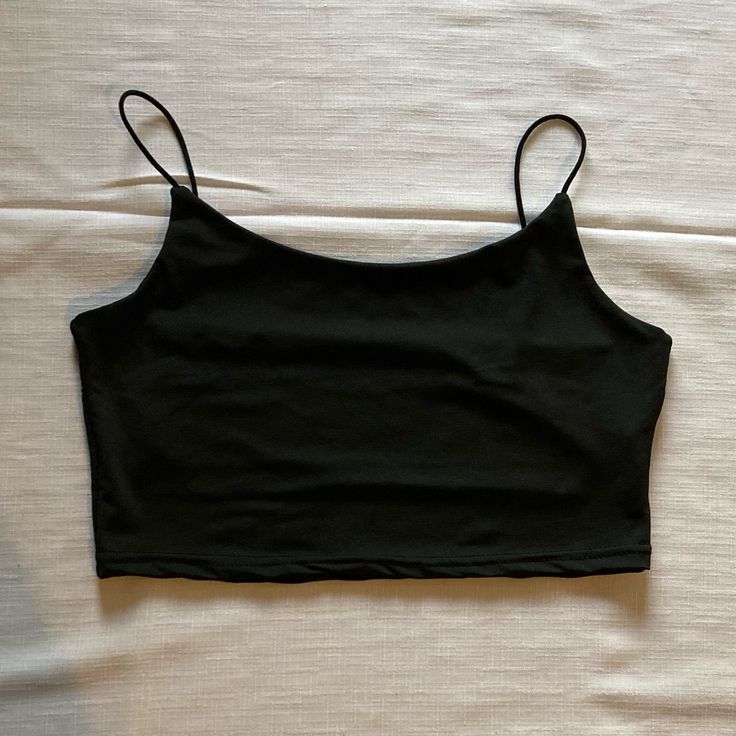 Spaghetti Strap Crop Top Size: Medium Color: Black Top Never Worn. Does Not Have Tags. Excellent Condition. Carefully Look At All The Pictures For Full Description! Black Crop Top Spaghetti Straps, Black Stretch Camisole With Spaghetti Straps, Black Summer Tops With Built-in Bra, Black Tank Crop Top With Built-in Bra, Black Camisole With Adjustable Tank Straps, Black Seamless Spaghetti Strap Tops, Black Camisole With Adjustable Spaghetti Straps, Black Camisole With Tank Straps, Black Tank Top With Adjustable Spaghetti Straps