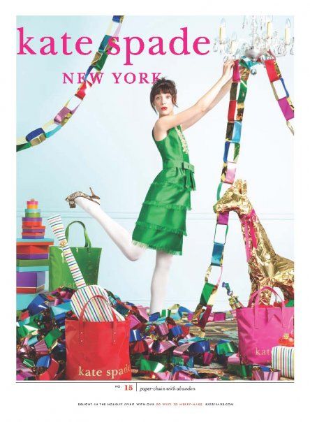 a woman in a green dress is surrounded by presents