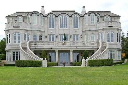 a large white house with many windows and stairs