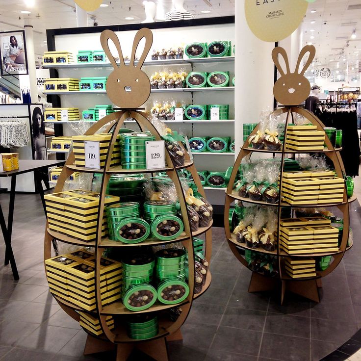 two cardboard easter decorations in the shape of eggs and bunnies with bunny ears on them