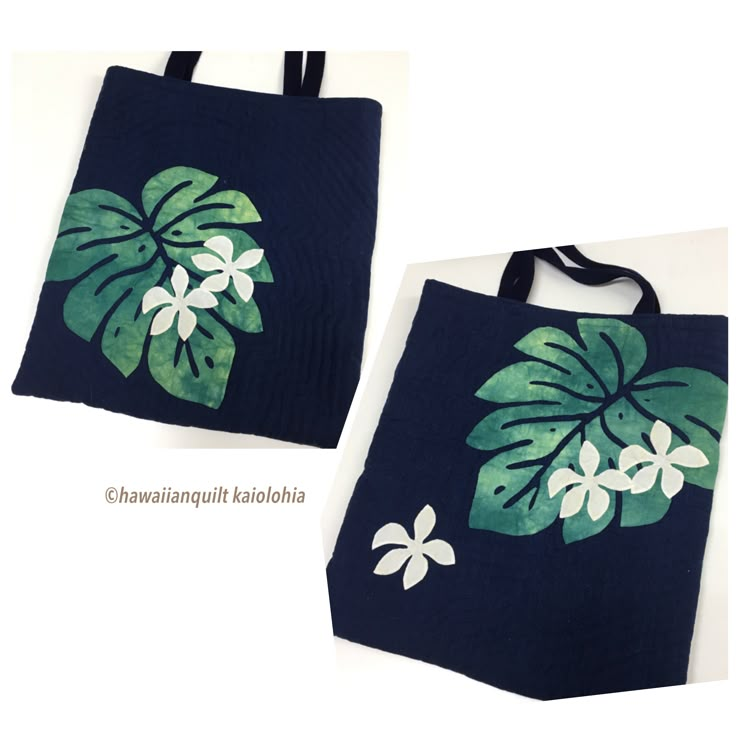 two blue bags with green and white flowers painted on the front one has a black handle