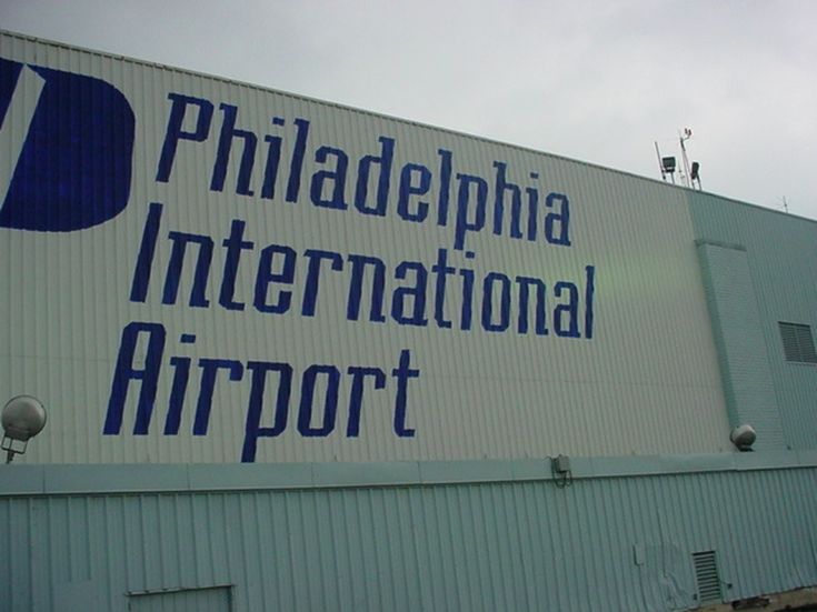 the sign for philadelphia international airport is shown in front of an industrial building with blue lettering