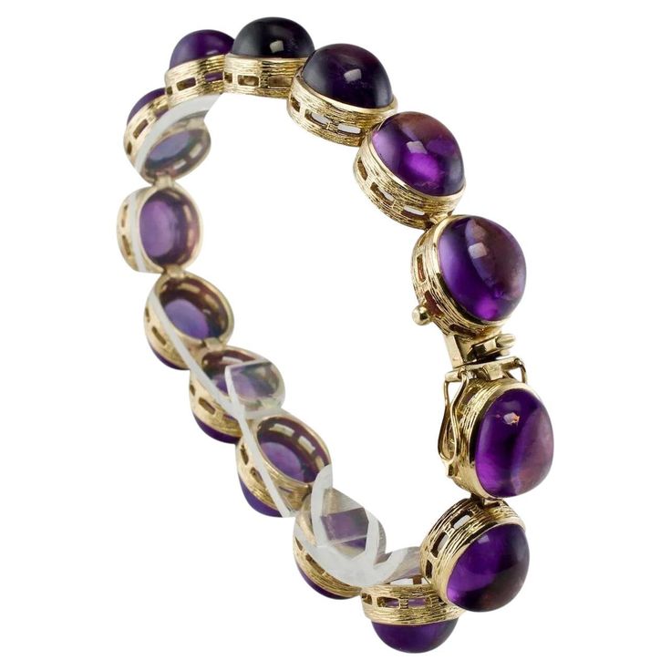 Amethyst Bracelet Cabochons 14K Gold 32.06 Tcw Vintage This gorgeous estate bracelet is finely crafted in solid 14K Yellow gold and it is set with genuine Earth mined Amethyst cabochons. Each gem is 10mmx 8mm for the total weight of 32.06 carats. These cabochons are great quality stones of good intensity. The bracelet is 7 inches long and8mm thick. Perfectly working clasp. The bracelet weighs a very substantial 31.8 grams and it is in great estate condition. *The matching Necklace is available i Luxury Vintage Purple Bracelets, Luxury Multicolor Cabochon Bracelet, Formal Yellow Gold Cabochons With Bezel Setting, Elegant Amethyst Cabochon Gemstones, Elegant Cabochon Amethyst Gemstones, Fine Jewelry Cabochon Bracelets As Gift, Luxury Purple Cabochon Jewelry, Luxury Amethyst Jewelry Stamped 14k, Yellow Gold Amethyst Bracelet