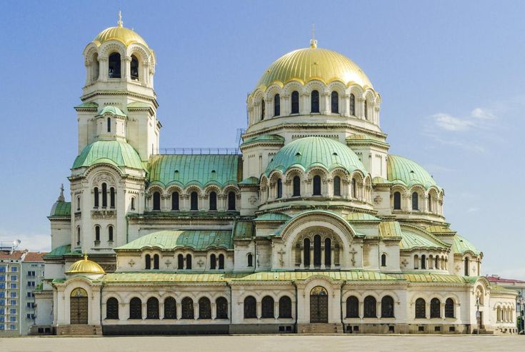 an ornate building with gold domes on top