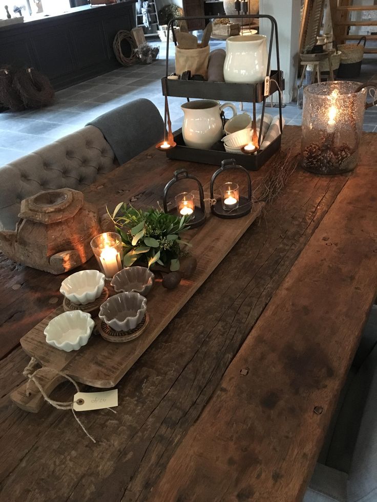 a wooden table topped with lots of candles