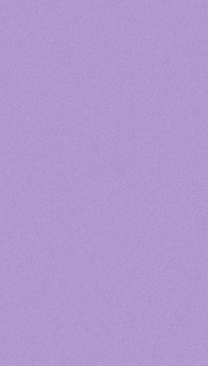 an airplane is flying in the sky on a purple background that appears to be overcast