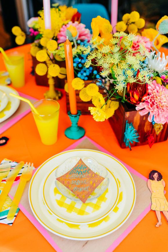 the table is set with flowers and plates