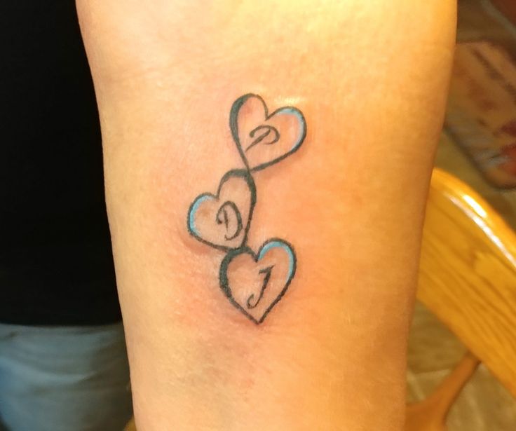 a couple of hearts tattoo on the arm