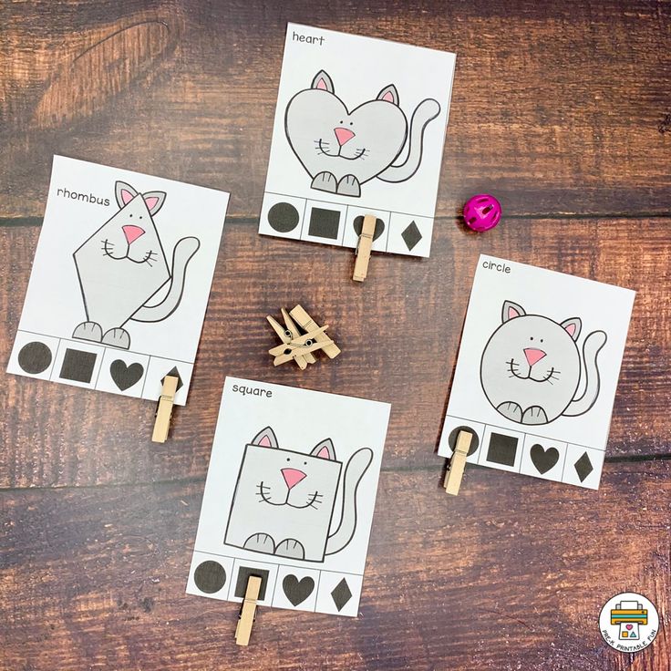 four cat match up cards with clothes pins on them, and two cats in the middle