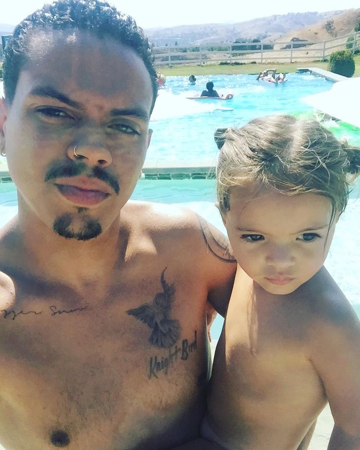 a man and child are standing in front of a swimming pool