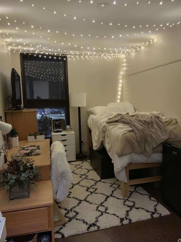 a bed room with a neatly made bed and lights