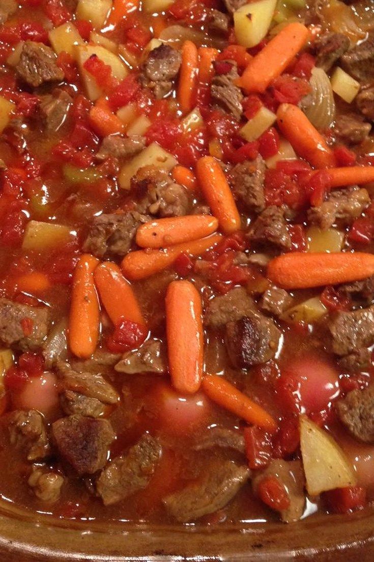 a bowl filled with meat and vegetables on top of a table