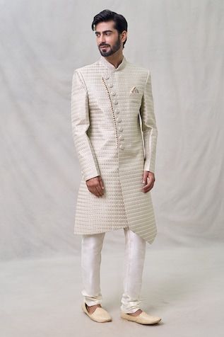 Light beige sherwani with thread embroidery. Paired with cream churidar. - Aza Fashions Designer Cream Kurta With Cutdana, Designer Cream Traditional Wear For Diwali, Off White Fitted Bandhgala Kurta, Designer Cream Bandhgala With Cutdana, Off White Fitted Bandhgala Straight Kurta, Fitted Off White Bandhgala Straight Kurta, Designer Cream Bandhgala For Diwali, Ceremonial Beige Kurta With Naqshi, Beige Naqshi Kurta For Ceremonial Occasions