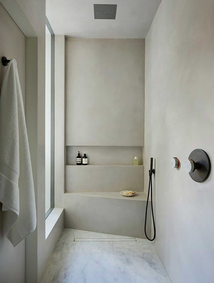 a bathroom with a shower head, sink and bathtub next to a wall mounted faucet