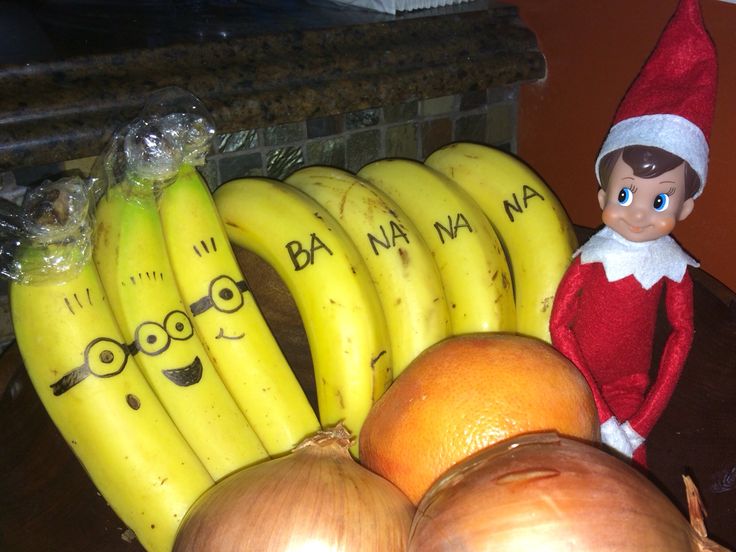 an elf is sitting next to bananas and onions