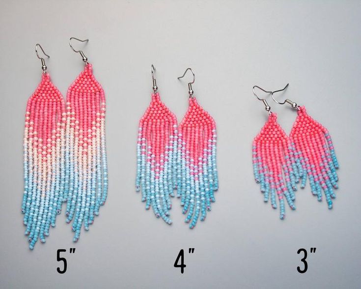 three pairs of pink, blue and white beaded earrings with fringes on them