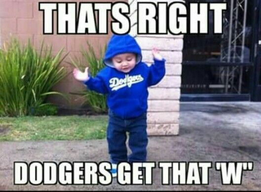 a little boy standing in front of a building with the caption, that's right dodgers get that w