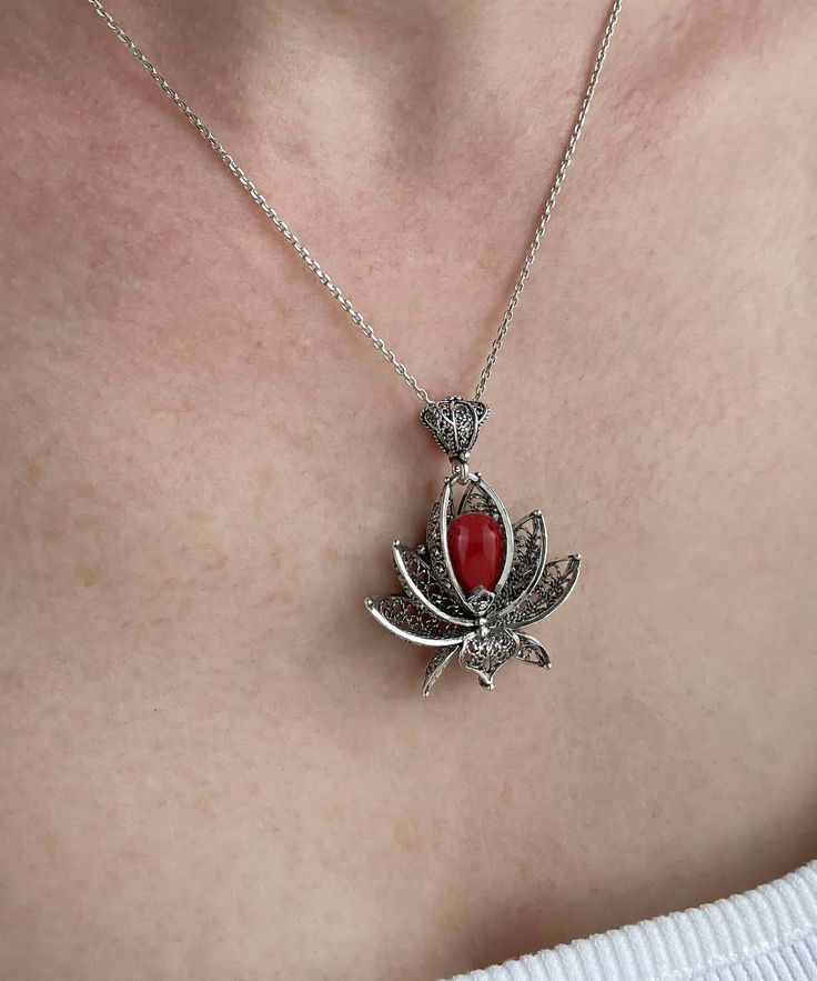 Add a touch of elegance to your everyday wear with this handcrafted filigree art lotus flower pendant necklace. Made of 925 sterling silver, this necklace features a beautiful coral gemstone that will surely catch everyone's attention. The pendant measures 1.65" / 42.00 mm in height and 1.35" / 33.00 mm in width, and comes with an optional 18.00"+2.00" / 50 cm sterling silver chain with extension and spring close closure. The coral gemstone is drop-shaped and measures 8x11 mm, making it the perf Elegant Flower Pendant Necklaces With Natural Stones, Elegant Gemstone Flower Necklace Gift, Elegant Flower Pendant Jewelry With Natural Stones, Elegant Lotus Flower Jewelry Gift, Spiritual Filigree Flower Pendant Necklace, Flower-shaped Natural Stones Jewelry For Gift, Elegant Flower Pendant Necklace For Meditation, Flower Shaped Natural Stone Jewelry Gift, Flower-shaped Natural Stone Jewelry Gift