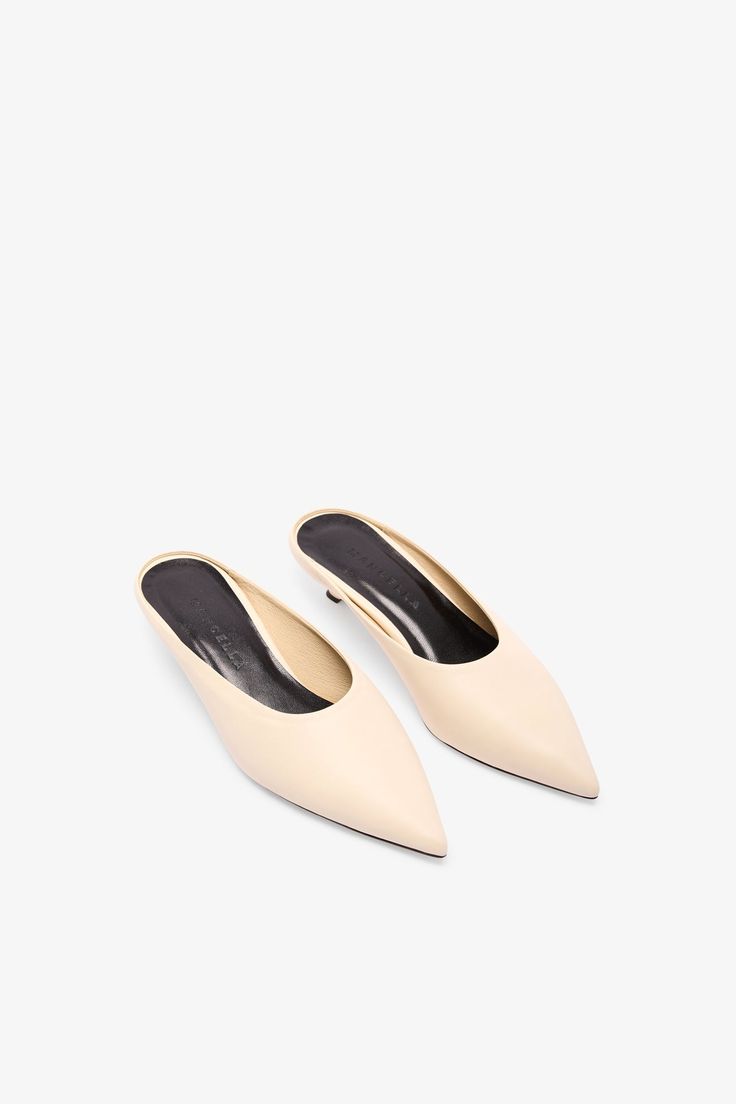 When simplicity stands out. Handcrafted from 100% Italian leather, our Celeste mules offer a sleek silhouette with a pointed toe for elevated minimalism. Providing a touch of lift, her comma heel will be your new favorite detail. Celeste's fresh and modern (while also comfortable and stable!), so count on her for all day in the office followed by drinks and then...well, who knows?...Celeste's game. | Martiza is shown wearing Celeste in black, in cream, and in santorini blue. Palak is shown weari Summer Slip-on Mules With Sculpted Heel, Sleek Summer Mules With 4-inch Heel, Spring Luxury Blue Mules, Luxury Slip-on Mules With Sculpted Heel, Modern White Flat-heel Mules, Santorini Blue, Leather Mules, Key Lime, Mules Shoes