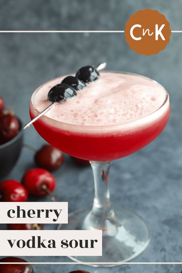 cherry vodka sour with cherries in the background