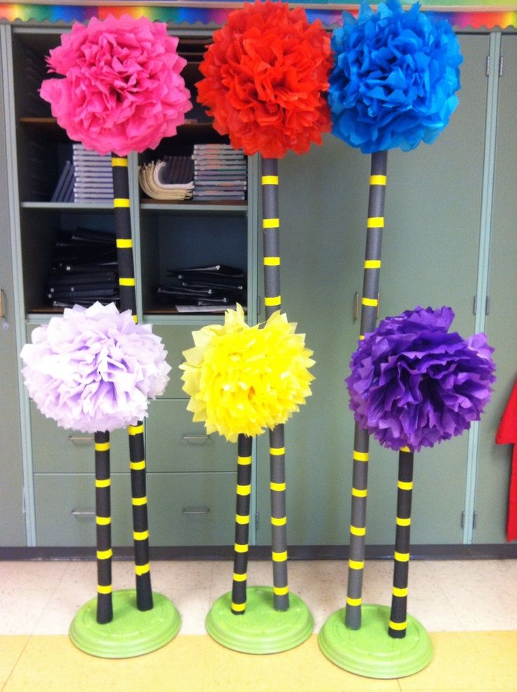 three vases filled with colorful paper flowers