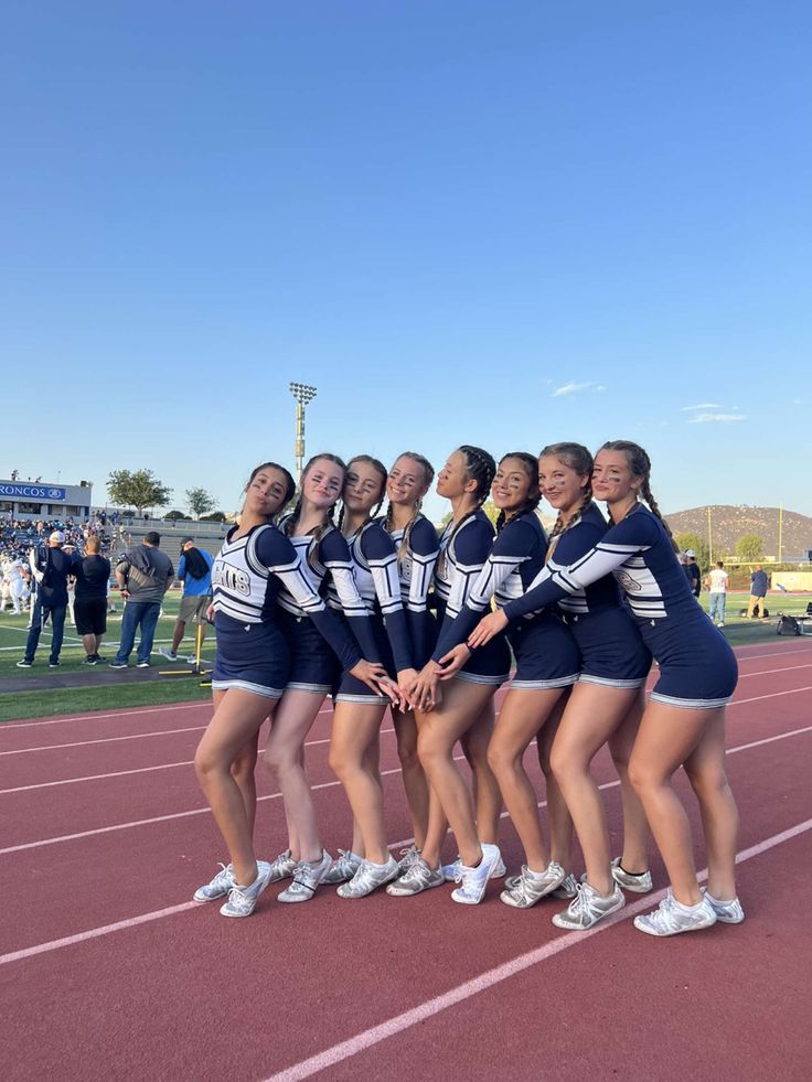 the cheerleaders are posing for a photo on the track