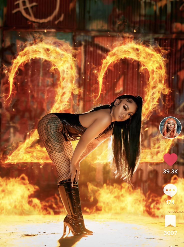 a woman in fishnet stockings and boots standing on fire