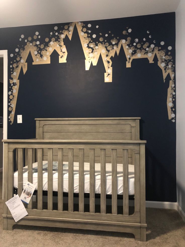 a baby's room painted in blue and gold