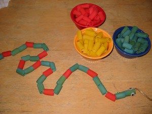 two bowls filled with candy sitting on top of a wooden table next to each other