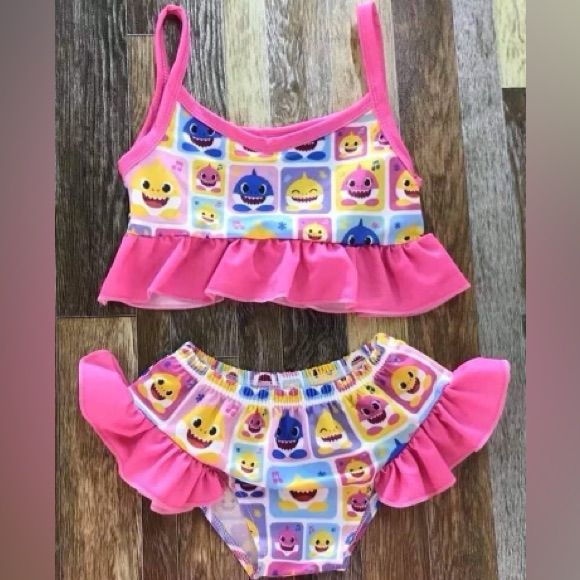 Girls Baby Shark Swimsuit This Swim Set Comes With Crop Ruffle Swim Top Ruffle Side Bottom Bow Brand Fitted Cartoon Print Sets For Playwear, Pink Cartoon Print Summer Sets, Pink Summer Sets With Cartoon Print, Cute Fitted Printed Swimwear, Playful Fitted Sets For Vacation, Playful Sleeveless Sets With Cartoon Print, Playful Sleeveless Cartoon Print Sets, Pink Summer Swimwear Sets, Pink Summer Swimming Set