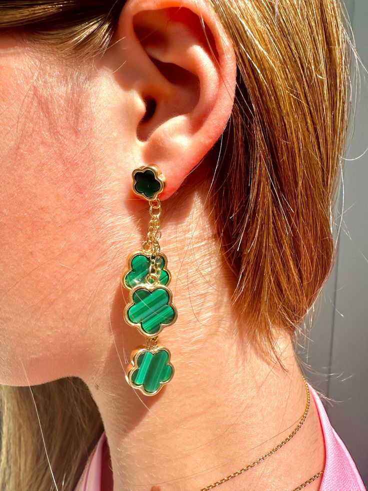 Upgrade your luck with our Luck Galore dangle earrings! These stunning emerald green and gold earrings will add a touch of sparkle to any outfit. Inspired by the iconic Van Cleef & Arpels lucky charm, these earrings are a must-have for any jewelry collection. Boost your luck and style with these elegant earrings. Green Dangling Charms Jewelry, Green Dangle Jewelry With Charms, Green Dangle Jewelry With Dangling Charms, Green Jewelry With Dangling Charms As Gift, Green Jewelry With Dangling Charms For Gift, Party Green Gold-plated Earrings, Green Pierced Jewelry For Party, Green Drop Earrings With Dangling Charms, Pierced Green Gold-plated Earrings