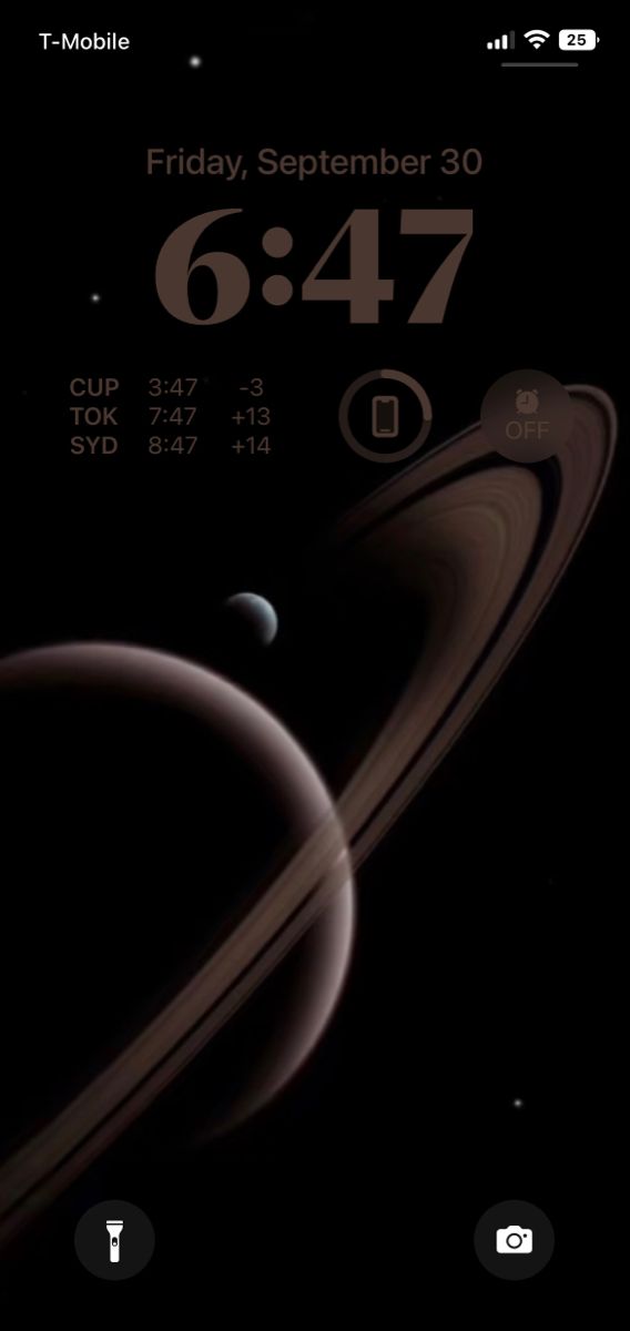 an iphone screen with the date and time on it, showing saturn's rings