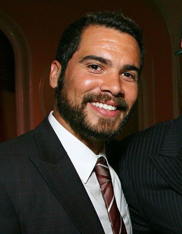 two men in suits are smiling for the camera