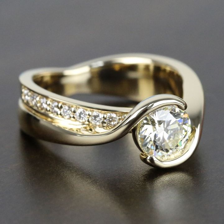 a close up of a ring with a diamond on it's center and two rows of diamonds in the middle