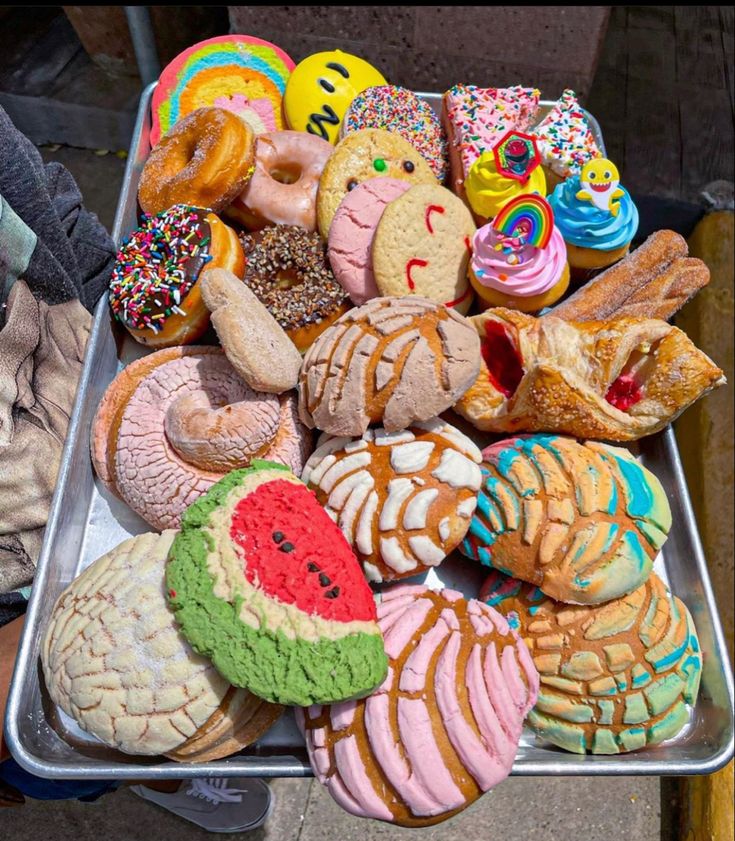 there are many different types of donuts on the tray